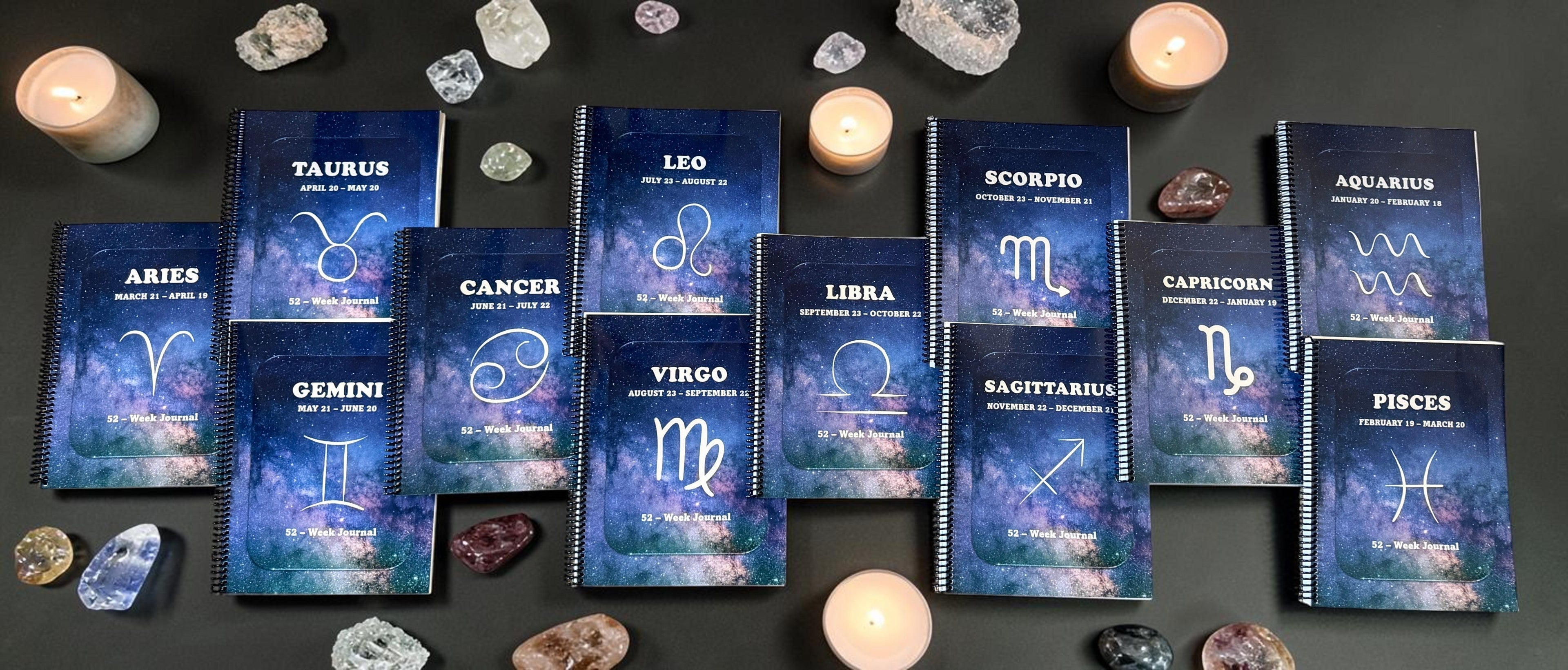 12 different spiral-bound zodiac journals with candles and healing on display for the Paperback Zodiac Journals Collection Picture for zodiacjournaling.com