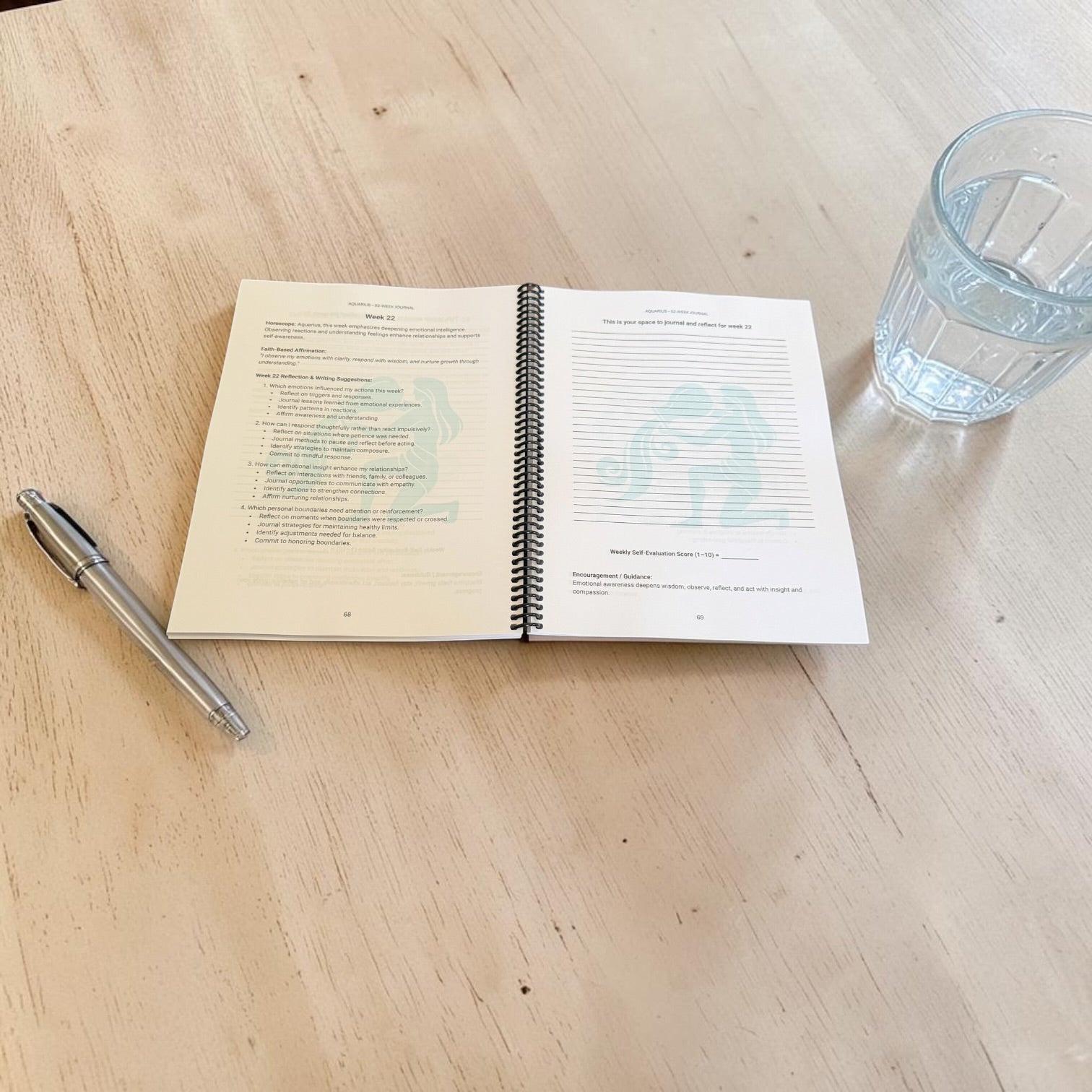 Aquarius 52-Week Zodiac Journal on a table top opened to an interior lay-flat position.