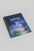 Capricorn 52-Week Zodiac Journal with grey studio light background