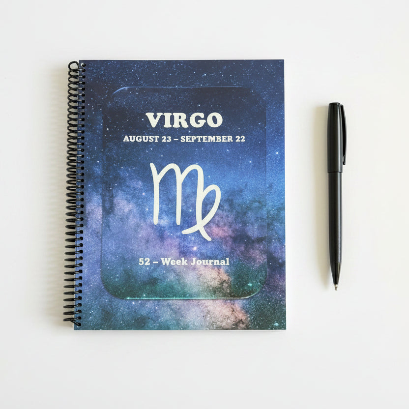 Virgo 52-Week Zodiac Journal on a  solid white surface with a pen next to it.